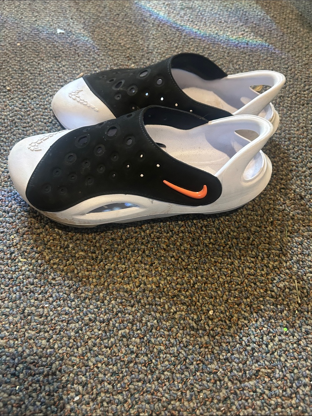 Nike Kids Black and White Slip-On Sandals with Orange Swoosh Accent